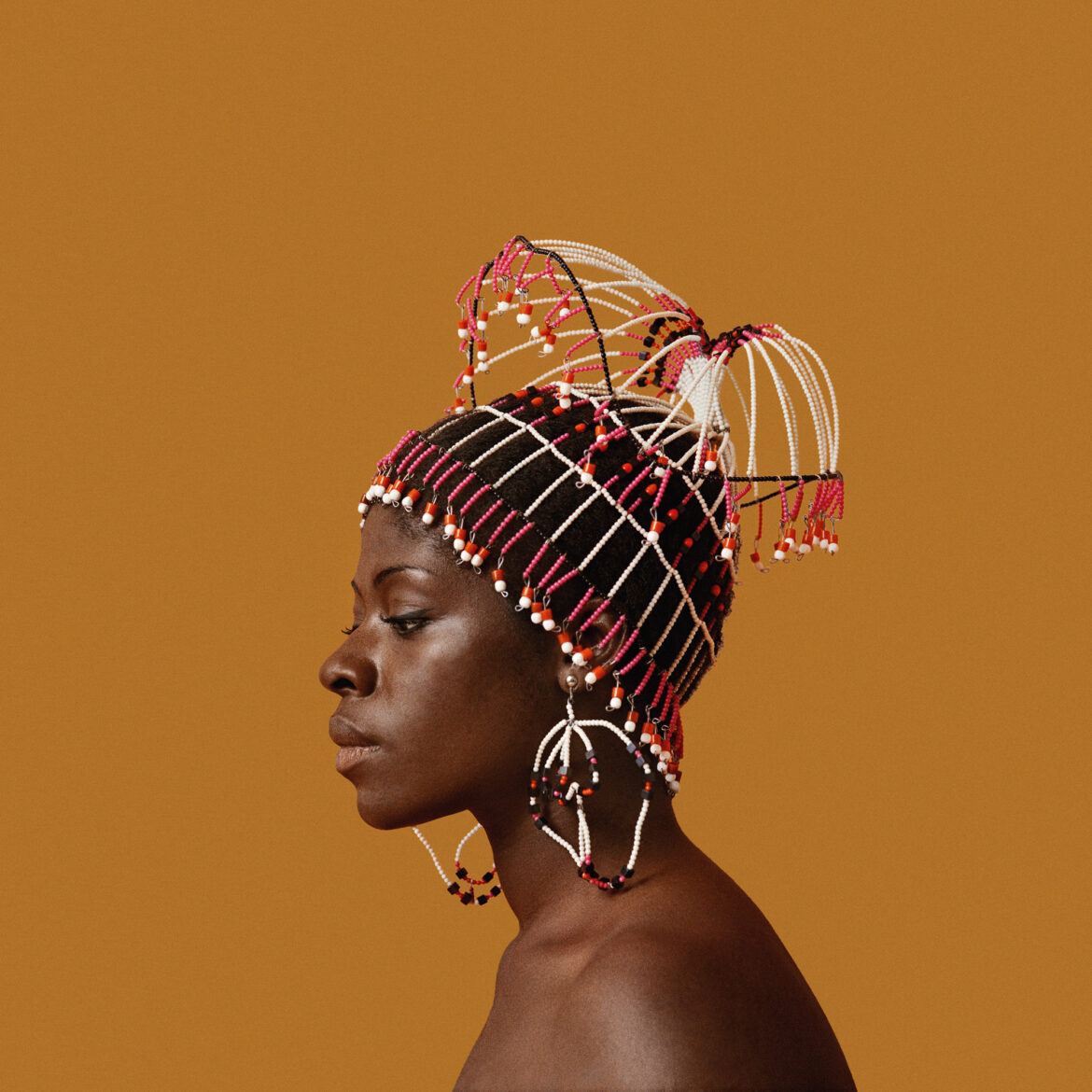 Kwame Brathwaite, Sikolo Brathwaite wearing a headpiece designed by Carolee Prince, African Jazz-Art Society & Studios (AJASS), Harlem, ca. 1968; from Kwame Brathwaite: Black Is Beautiful (Aperture, 2019) Kwame Brathwaite/Philip Martin Gallery, Los Angeles / Aperture