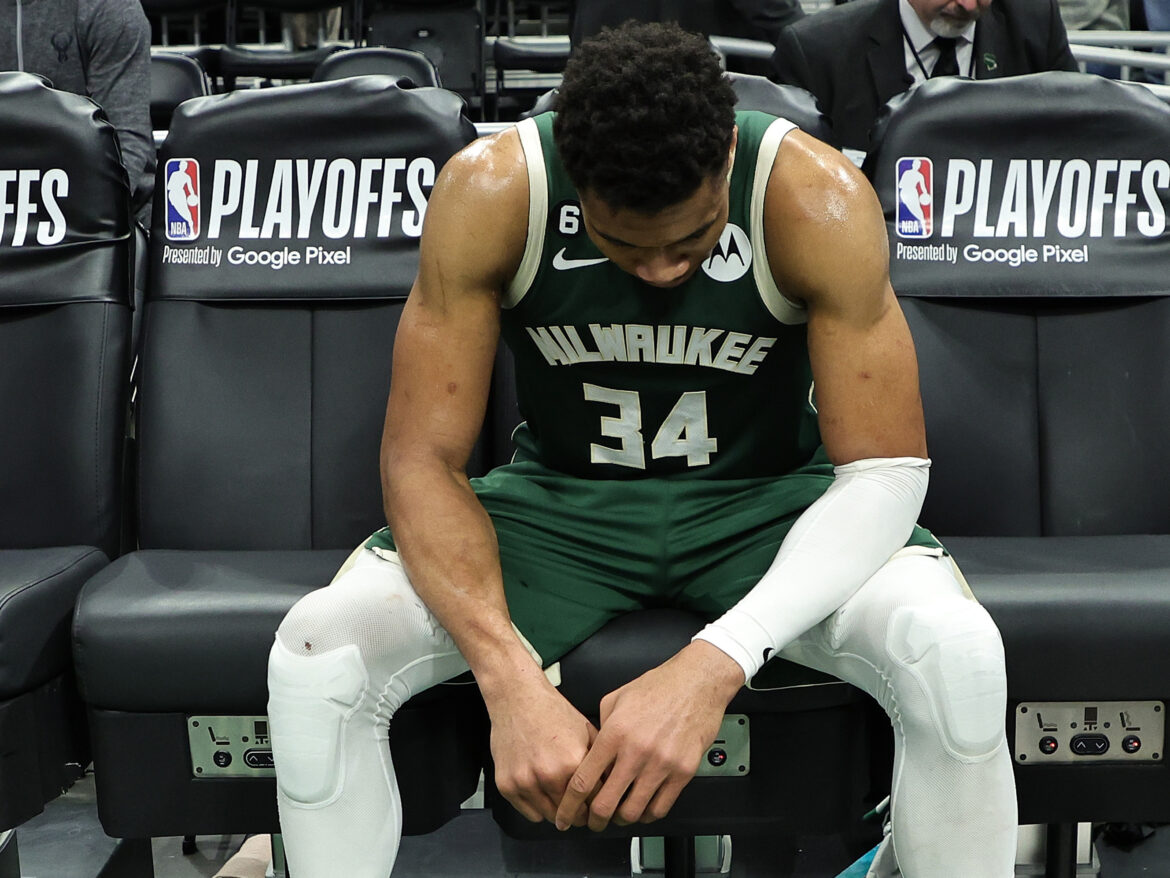 Giannis Antetokounmpo of the Milwaukee Bucks sits on the bench after losing Game 5 of the Eastern Conference First Round Playoffs against the Miami Heat in overtime. Stacy Revere/Getty Images