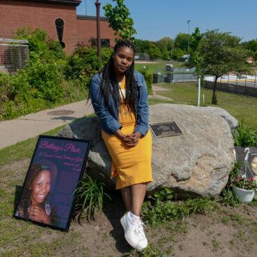 Lakeisha Lee placed flowers at the base of a monument honoring her late sister Brittany Clardy Thursday, May 26, in Saint Paul. Clardy went missing more than a decade ago and was found murdered. Dana Ferguson/MPR News