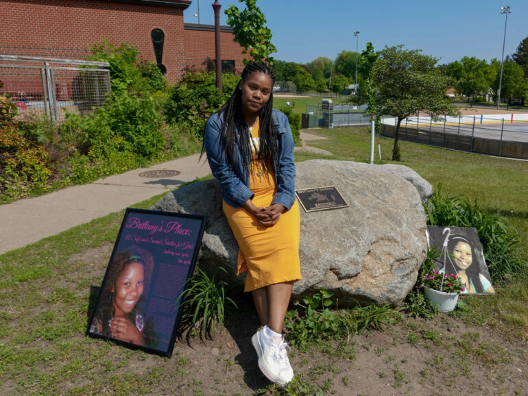 Lakeisha Lee placed flowers at the base of a monument honoring her late sister Brittany Clardy Thursday, May 26, in Saint Paul. Clardy went missing more than a decade ago and was found murdered. Dana Ferguson/MPR News