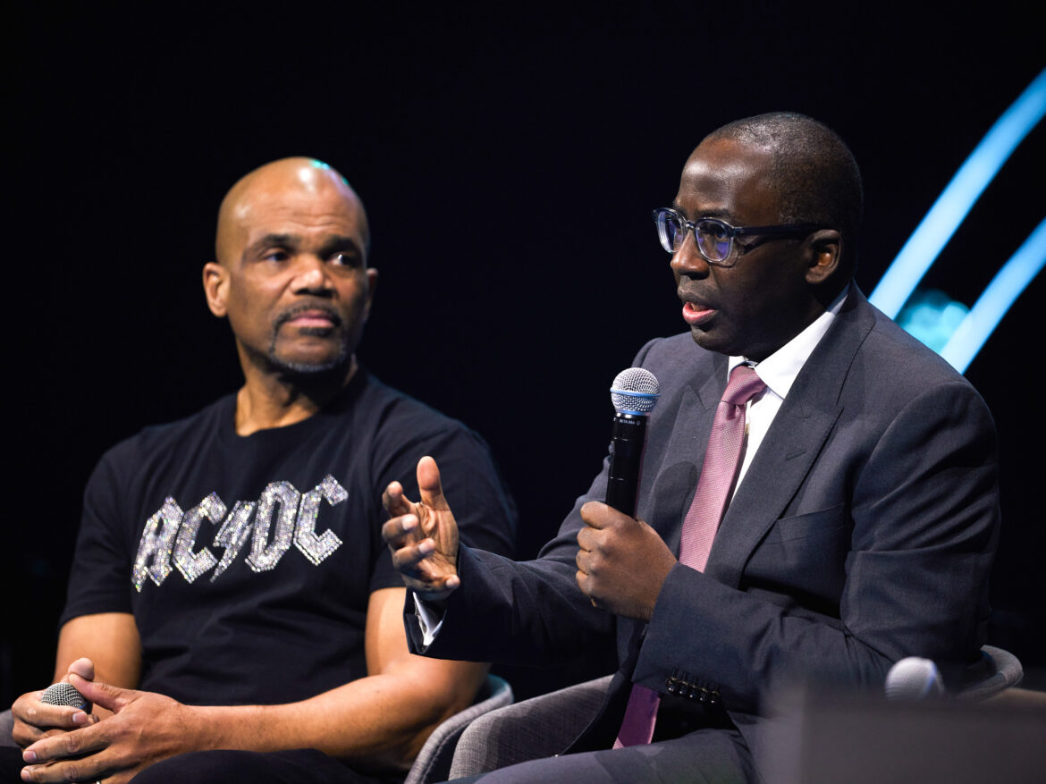 Dr. Olajide Williams (right) was instrumental in creating the "Stroke Ain't No Joke" hip-hop song in collaboration with rapper Doug E. Fresh. He's sitting next to Darryl "DMC" McDaniels of Run-DMC during a panel on hip-hop and public health at the Skoll World Forum. Skoll Foundation