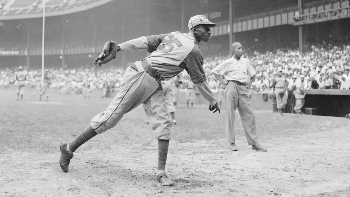 Kansas City Monarchs pitching great Satchel Paige warms up at New York's Yankee Stadium Aug. 2, 1942 for a Negro League game between the Monarchs and the New York Cuban Stars. Matty Zimmerman/AP