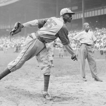 Kansas City Monarchs pitching great Satchel Paige warms up at New York's Yankee Stadium Aug. 2, 1942 for a Negro League game between the Monarchs and the New York Cuban Stars. Matty Zimmerman/AP