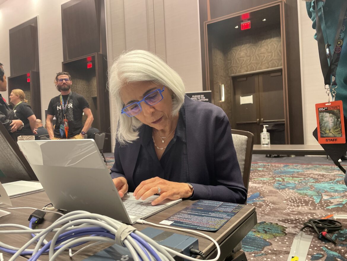 Arati Prabhakar, head of the White House's Office of Science and Technology Policy, tries out the AI challenge at Def Con. The White House urged tech companies to have their models publicly tested.
Deepa Shivaram/NPR