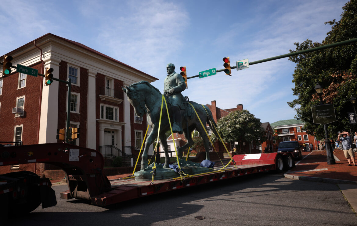 A flatbed truck carries a statue of Confederate Gen. Robert E. Lee from the Market Street Park July 10, 2021 in Charlottesville, Va. Initial plans to remove the statue sparked the infamous "Unite the Right" rally where Heather Heyer was killed, two state troopers died, and dozens of people were injured.
Win McNamee/Getty Images