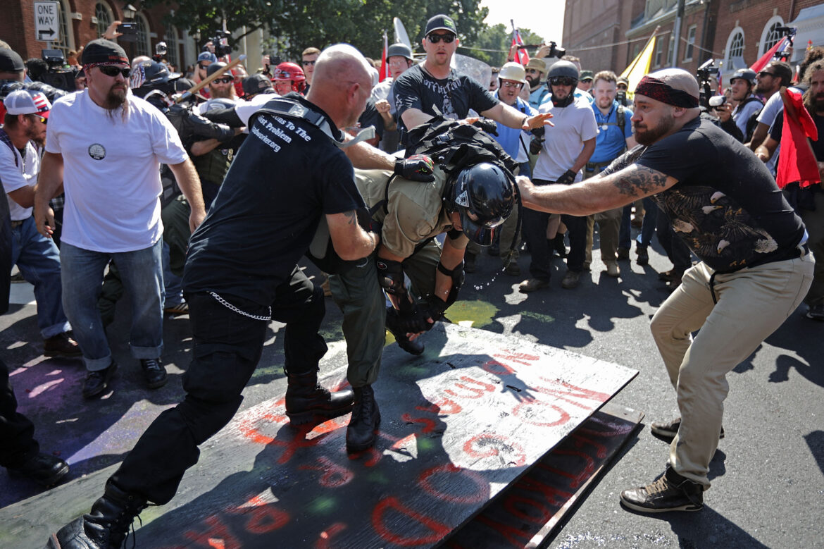 White nationalists, neo-Nazis, the Ku Klux Klan and members of the "alt-right" attack each other as a counter protester (R) intervenes during the melee at the Unite the Right rally August 12, 2017 in Charlottesville, Va.
Chip Somodevilla/Getty Images