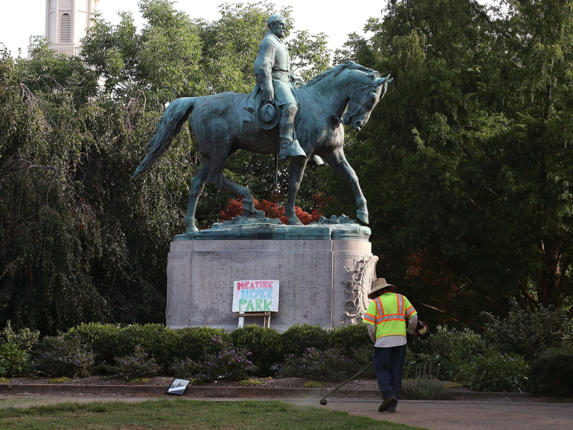 A homemade sign that says Heather Heyer Park rests at the base of the statue of Confederate Gen. Robert E. Lee in a downtown Charlottesville, Va. park on August 18, 2017. Heyer was killed by a neo-Nazi during a white nationalist rally.
Mark Wilson/Getty Images