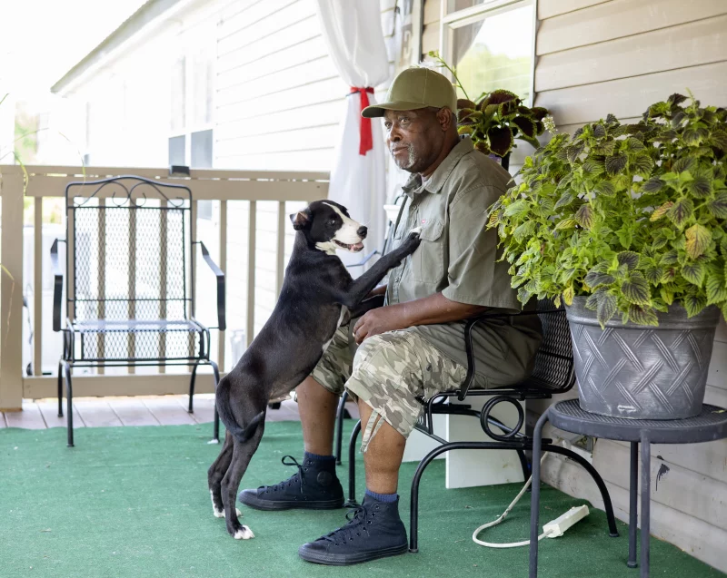 Joshua McCray, of Kingstree, South Carolina, retired as a public bus driver after he caught COVID and nearly died. During the pandemic, Black Americans were more likely to hold jobs — in fields such as transportation, health care, law enforcement, and food preparation — that the government deemed essential to the functioning of society, making them more susceptible to the virus.

Gavin McIntyre for KFF Health News