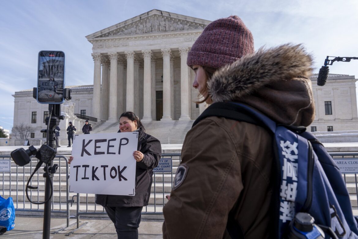 Tik Tok ban: Callie Goodwin of Columbia, S.C., holds a sign in support of TikTok outside the Supreme Court on Jan. 10 in Washington, D.C. Goodwin, a small-business owner who sells personalized greeting cards, says 80% of her sales come from people who found her on TikTok. Jacquelyn Martin/AP